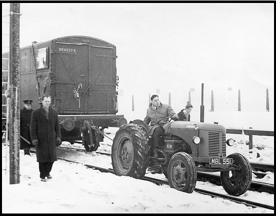 Gordon Dennett, manager of the Bracknell branch, pulling a railway truck at Bracknell Station during severe weather in 1963.