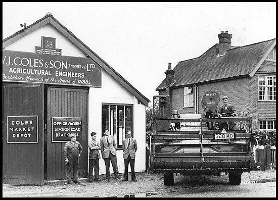 A close-up of Coles premises, with a Massey Harris combine harvester leaving the works.